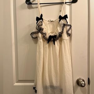 Victorias Secret Size L Sheer cream babydoll with black bow decor.